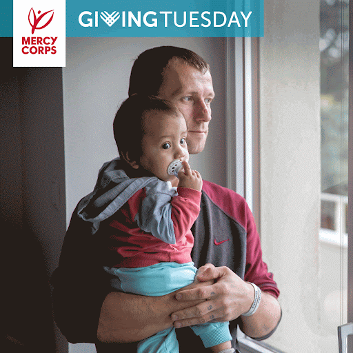 Subtle animation of man holding a child and looking out the window.