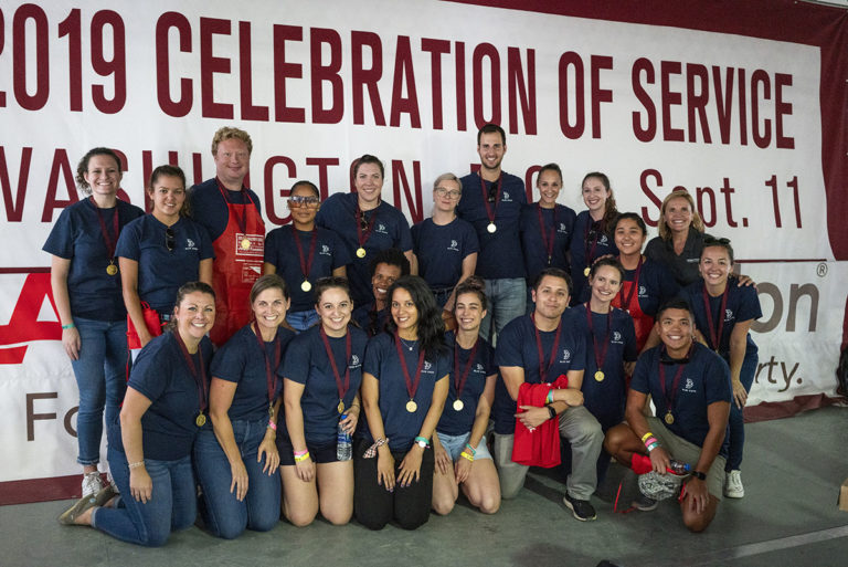 Blue State DC team gathered in front of AARP sign for AARP Foundation's 2019 Celebration of Service event