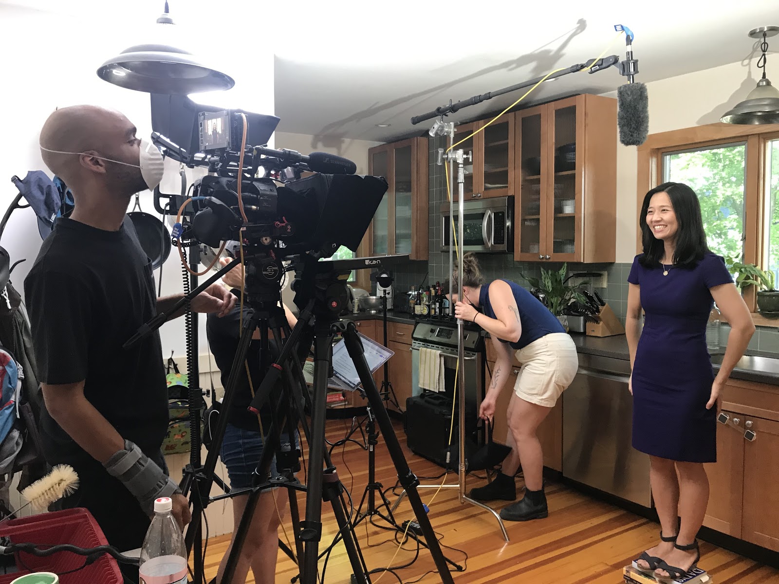 Candidate Wu in front of camera, camera crew standing by