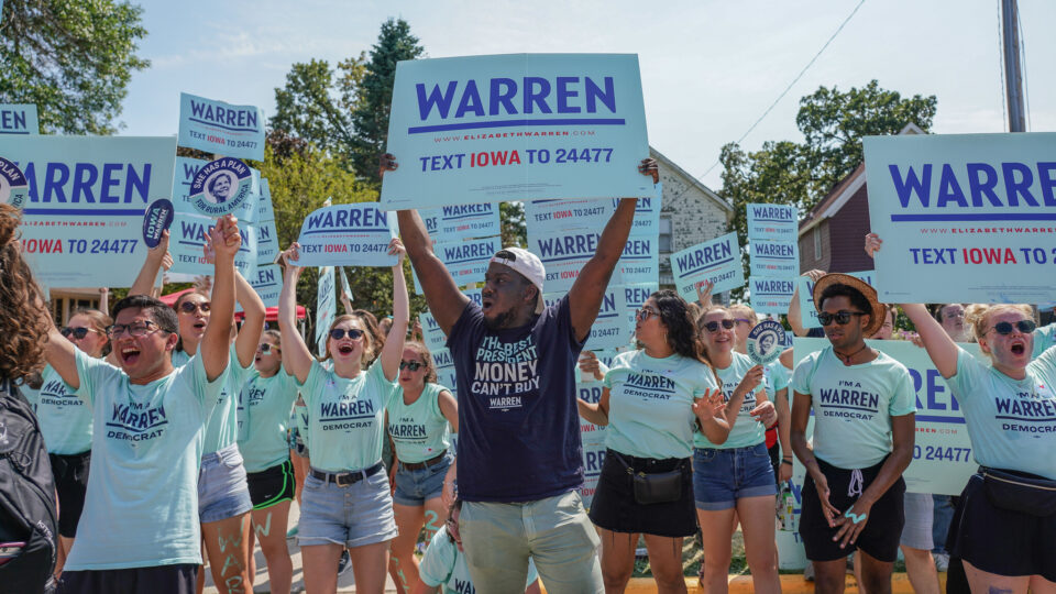 Elizabeth Warren supporters holding Warren signs