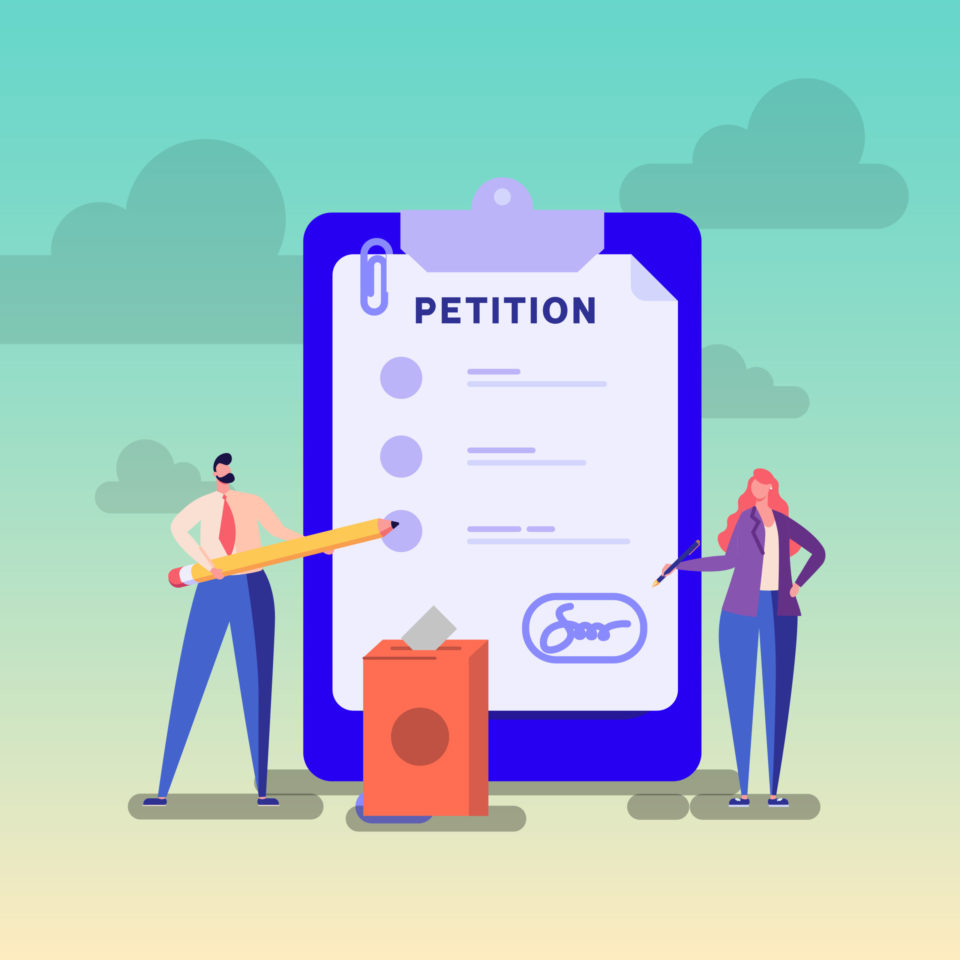 Two individuals holding a large pencil, in front of a large clip board with a petition page.