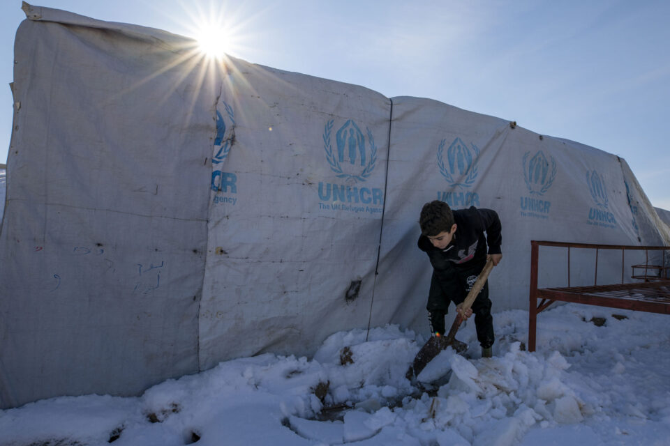 Young boy shovels snow next to their shelter to prevent water from leaking into it. Essian IDP camp near Duhok. ; This year (2022) low temperature drops have been recorded in Iraq, with temperatures dropping to subzero reaching -8 Celsius in several provinces in the northern mountainous regions in Kurdistan Region of Iraq. Extreme cold has been witnessed in some IDP camps, making it very difficult and unbearable for those most vulnerable, as there is nothing but thin walls or sometimes plastic sheets to protect them from the severe cold. In the last few days, the government announced public holidays on more than one occasion and schools were closed to protect children from the elements. More snowstorms are expected in the coming weeks, amid very low temperature. UNHCR distributed cash assistance for fuel and other emergent needs, to help the most vulnerable refugees and IDP families prepare for winter and purchase fuel for heating but as temperatures continue to drop more help is needed.