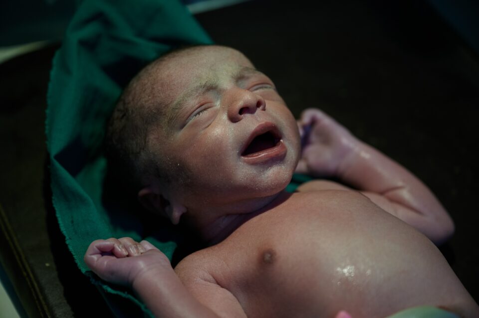 After a cesarean section, a newborn baby is weighed on a scale by a member of the healthcare team at Al-Farabi Hospital which is managed by UNFPA implementing partner PNFWH (Pakistan National Forum for Women’s Health), Keti Binder, Thatta District, Sindh province.